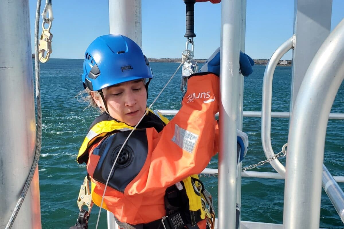 A woman works on a wind turbine